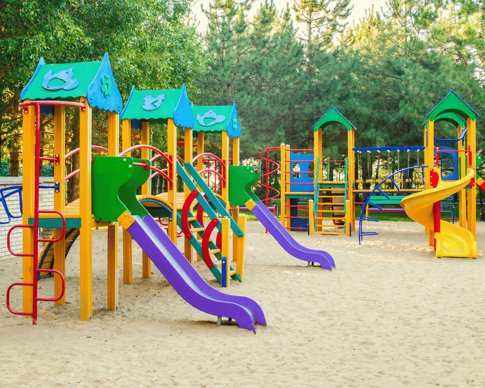 Colorful playgrounds for kids in outdoor area with trees | Bluejayset Playground Heaven